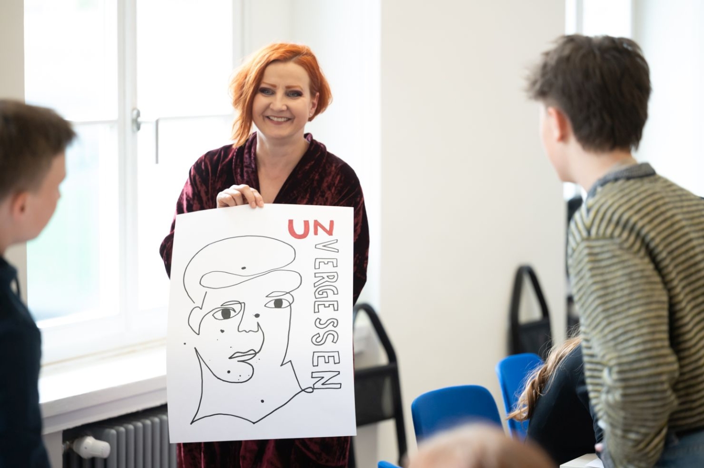A woman presents a poster.
