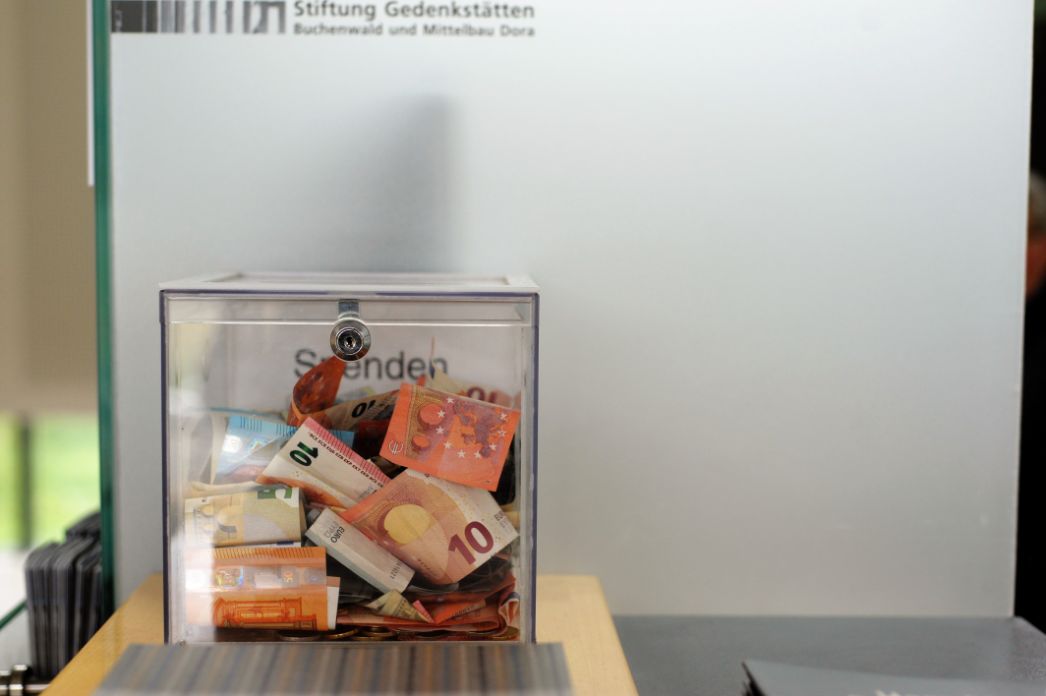 Auf dem Bild ist eine durchsichtige Spendenbox zu sehen, die mit allerhand Euro-Scheinen gefüllt ist.