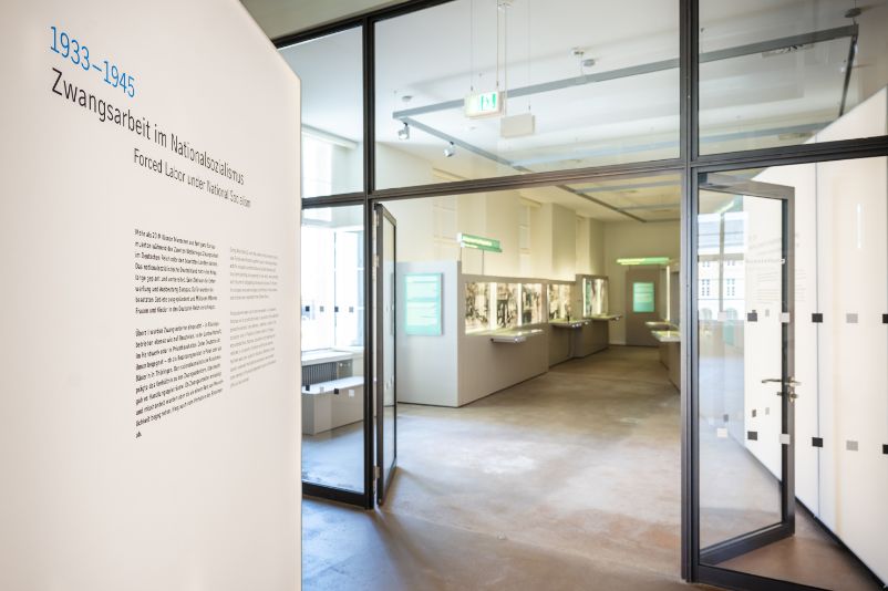 The picture shows a man inspecting one of the display cases in the exhibition on the subject of forced labour under National Socialism.